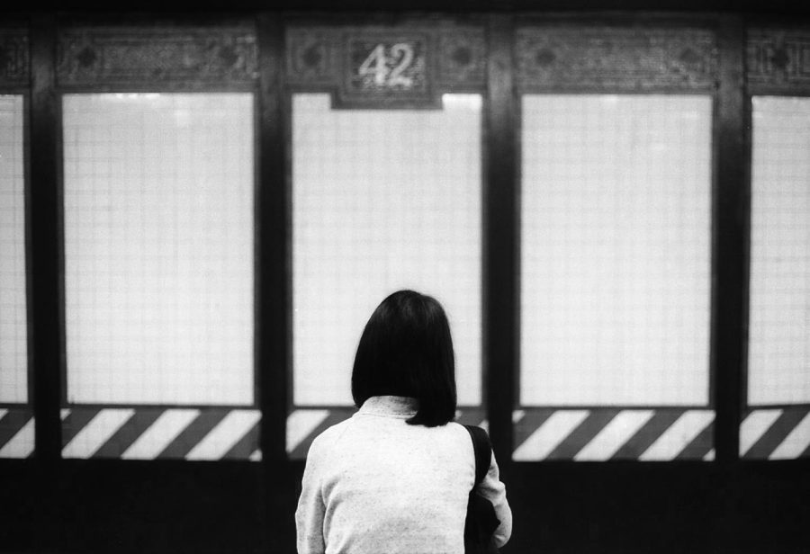 A subway rider stands on the Times Square station platform. Riders are on alert after a rise in assaults at subway stations. (Staff Photo by Ryan Walker)