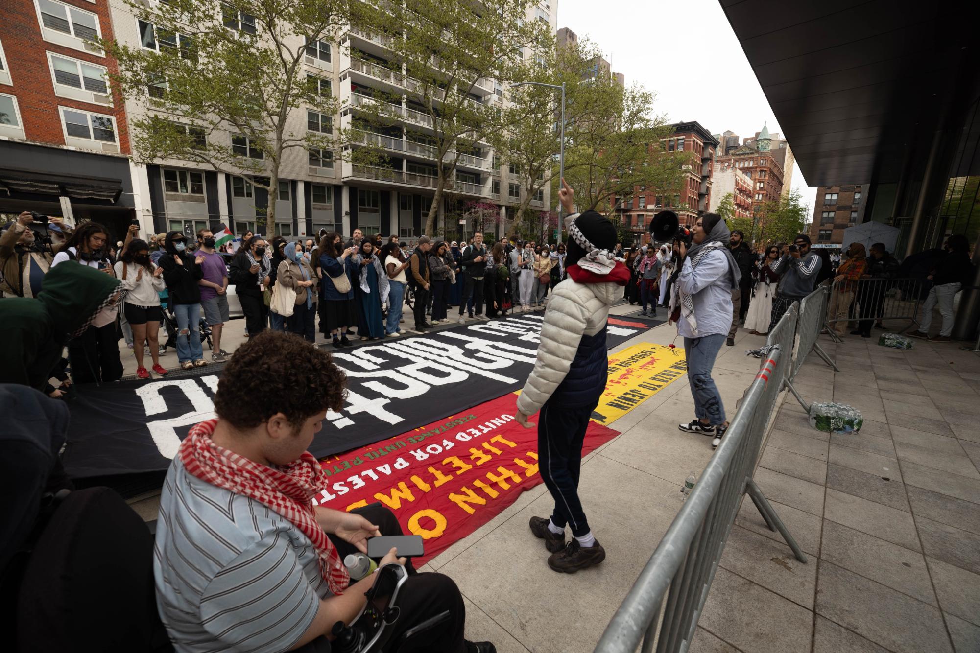 SMST5637 Protesters gather outside the Paulson Center. A banner that reads “Free Palestine” is on the floor.