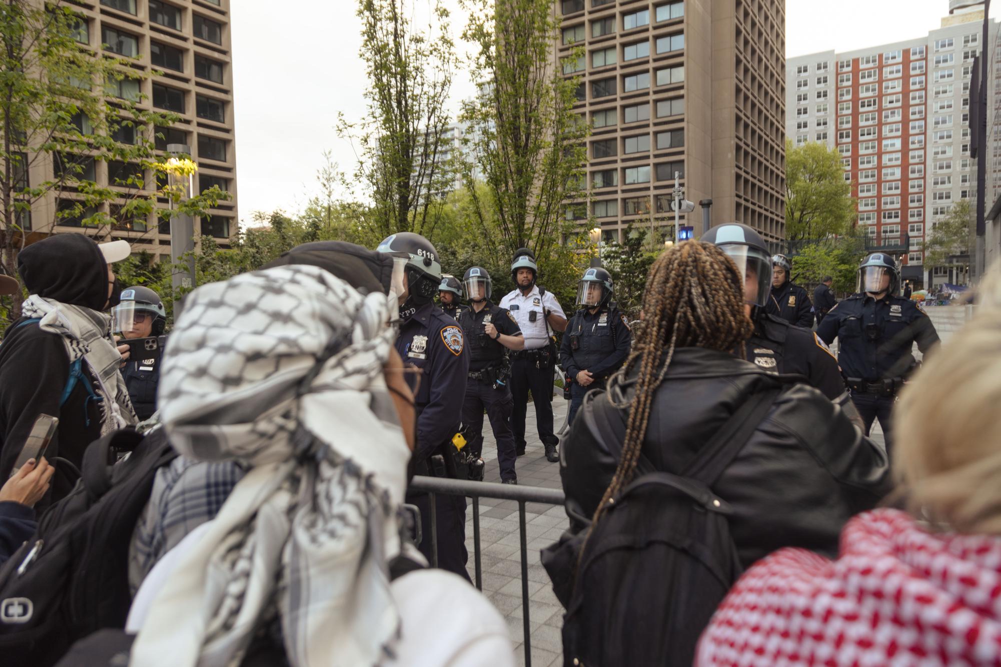 SMST8090 Protesters confront N.Y.P.D. officers outside the Houston Street entrance to the Greene Street Walkway.